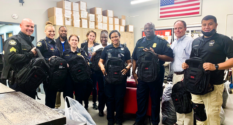 Jimmy Cushman of Halpern donates backpacks to police officers of APD Zone 4