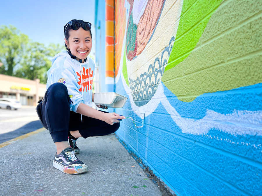 Artist Leah Abucayan working on the new mural at Pinetree Plaza, along Buford Highway in Doraville