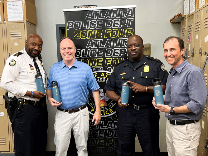 Property Manager Jimmy Cushman donates tumblers to APD Zone 4